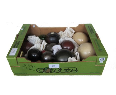 A red hardstone polished sphere, a Lignum Vitae bowling ball, and a quantity of hardstone, glass and ceramic spheres (qty).