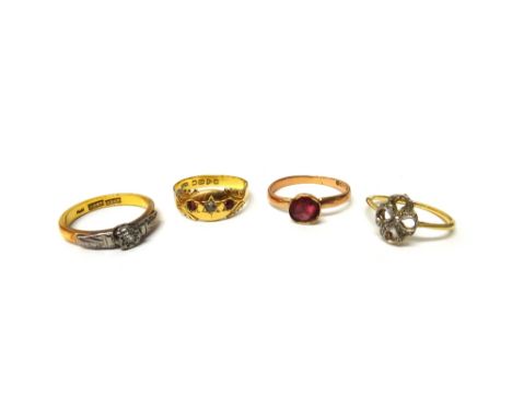 A gold and platinum, diamond set single stone ring, detailed '22ct PLAT', an 18ct gold, diamond and red gem set three stone r