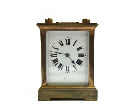 A brass cased carriage clock, with white enamel dial and Roman numerals enclosing a two train movement, the rectangular form 