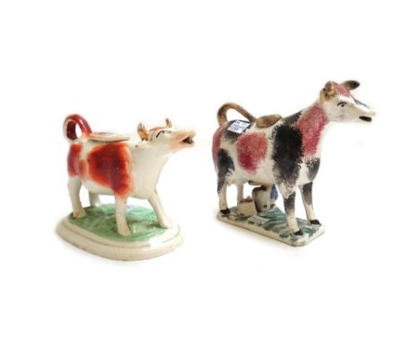 Ten 19th century pottery cow creamers, including; a Prattware type pink and black sponge decorated cow, two black and gilt sp