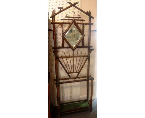 A Victorian bamboo hall stand, with bevelled mirror back over six division stick stand, 90cm wide x 210cm high.