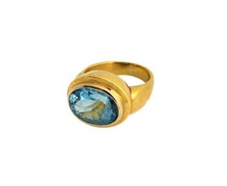 A gold and aquamarine single stone ring, collet set with an oval cut aquamarine, ring size O, gross weight 12.8 gms.  Illustr