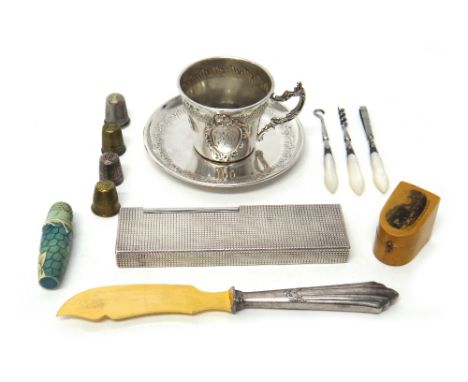 A French tea cup and saucer, a silver plated Dupont Paris rectangular large gas lighter, length 14cm, three steel implements,