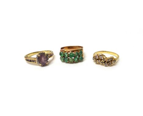 A gold and diamond set ring, claw set with circular cut diamonds in an abstract design, a 9ct gold, amethyst and diamond set 