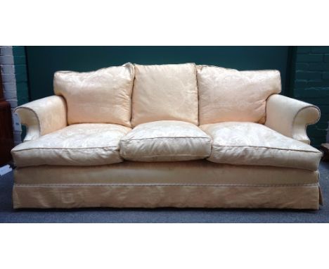 A 20th century patterned gold upholstered hump back sofa with roll over arms, 210cm wide x 83cm high. 