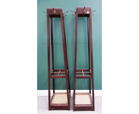 A pair of Arts and Crafts style coat/stick stands, each of tapering square section form with four division mid-tier and metal