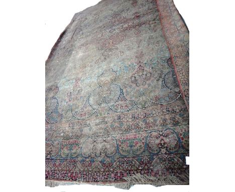 A Kerman carpet, Persian, the allover pattern with linear design and floral sprays; a complementary border, 512 x 330cm. 