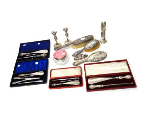 A group of silver mounted wares, comprising; four cased button hook and shoe horn sets, two various hairbrushes, a hand mirro