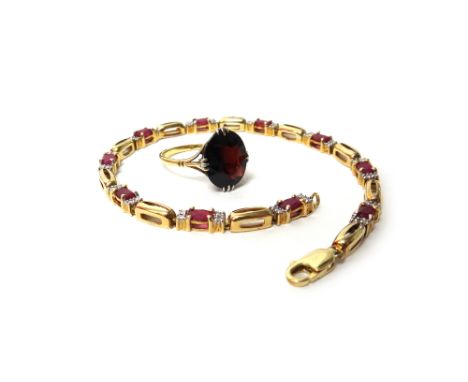 A gold and garnet set single stone ring, claw set with an oval cut garnet, detailed 18 CT, ring size N and a half and a gold,