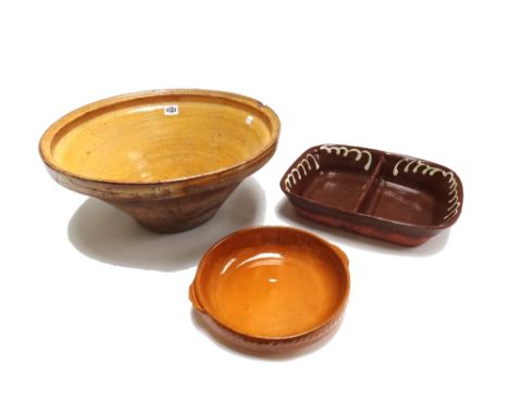 A collection of slipware pottery, 20th century, including; a large mixing bowl (44cm diameter), a yellow ground jug and basin