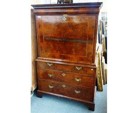 A Queen Anne figured walnut secretaire chest, with flush frieze drawer over fall and fitted interior, above two short and two