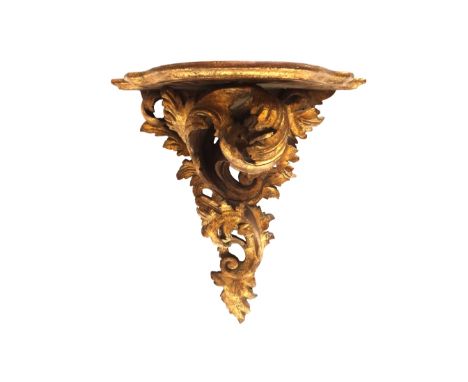 An early 20th century Rococo Revival gold painted acanthus scroll wall bracket, 41cm wide x 46cm high.  Illustrated
