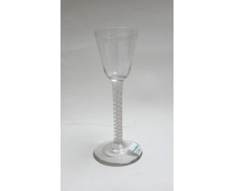 An opaque twist wine glass, circa 1765, the rounded funnel bowl raised on a double series opaque twist stem and plain foot, 1