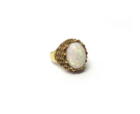 A gold ring, in a stepped and pierced design, mounted with an oval opal, detailed 585, ring size L and a half, gross weight 4