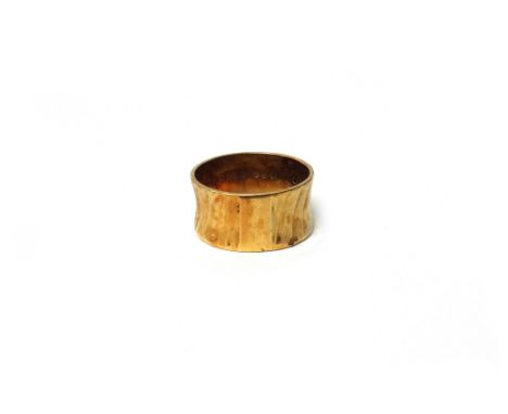 An 18ct gold wide band wedding ring, with a textured finish, London 1962, ring size T, weight 6.2 gms.