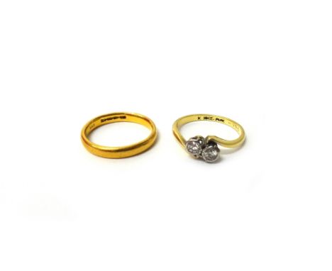 A gold and platinum, diamond set two stone ring, in a crossover design, detailed '18ct PLAT', ring size L and a half and a 22