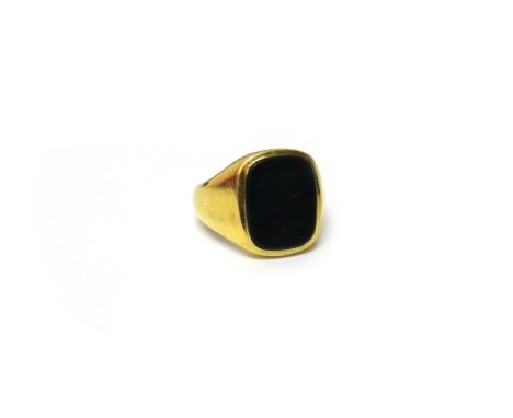 An 18ct gold and bloodstone set plain signet ring, London 1976, ring size R, gross weight 12.5 gms.