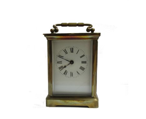 A brass cased carriage timpiece, late 19th century, with white enamel dial and a single train movement with a leather travel 