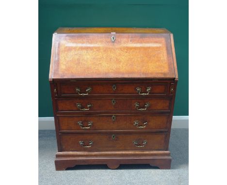 An 18th century and later figured walnut bureau, with fitted interior over four long drawers, on bracket feet, 89cm wide x 10