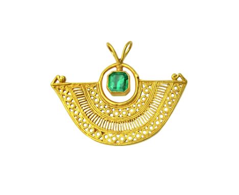 A Columbian gold and emerald set pendant, in a pierced fanned shaped ethnic design, mounted with a cut cornered square step c