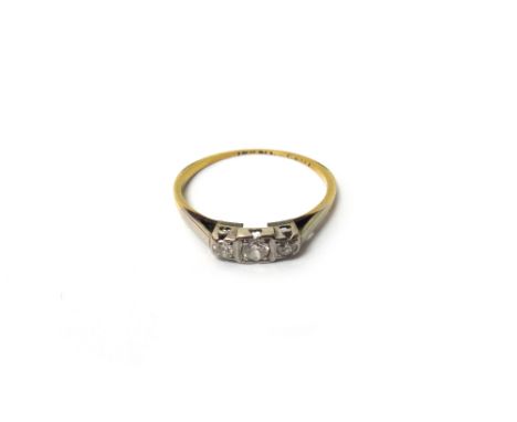 A gold and platinum, diamond set three stone ring, mounted with a row of circular cut diamonds, ring size N, with a box.