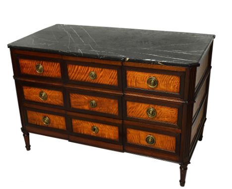 A late 18th century French commode, the marble top over a mahogany and satinwood breakfront three drawer base on turned suppo