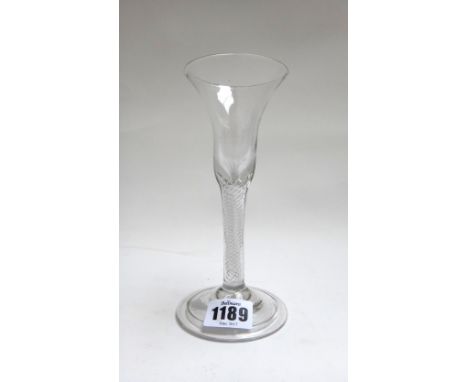 An airtwist wine glass, mid 18th century, the trumpet bowl raised on a multi-series airtwist stem and folded foot, 17cm. high