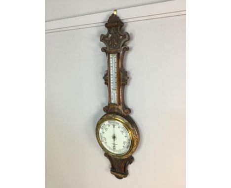 VICTORIAN OAK CASED WHEEL BAROMETER, by McPherson Bros. Glasgow, with white enamel dial below a mercury thermometer, carved t
