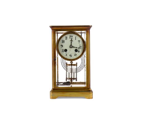 EDWARDIAN BRASS MANTEL CLOCK, with two train movement, the white enamel dial with Arabic numerals, contained in a brass four 