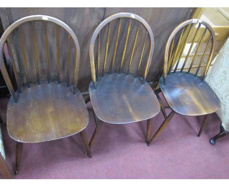 Three Vintage and Dark Ercol Dining Chairs, with hooped backs, rail supports, splayed legs.