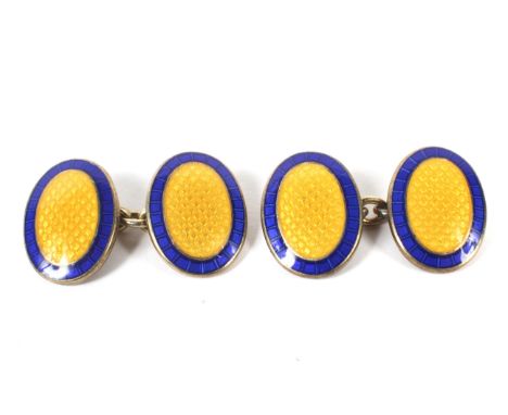 A pair of ornate silver gilt cufflinks by Asprey. Of oval form, decorated with yellow and blue enamel, 15g Condition Report: 