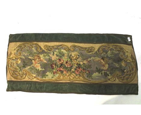 A 19th century tapestry panel. The needlepoint image depicts cherubs either side of flowers, with gilt and velvet trim, 125cm
