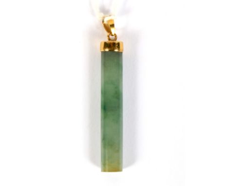 A comtemporary yellow metal and jade pendant. The jade of cylindrical form, L4.5cm