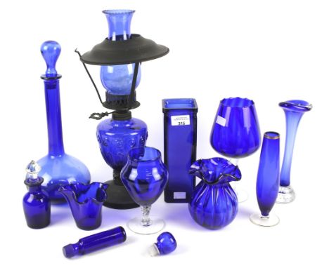 An assortment of Bristol blue glassware. To include an oil lamp, vases, etc, largest approximately 42cm