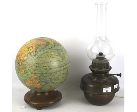 A paper covered globe adapted into a table light and a brass oil lamp. The table lamp mounted on a turned wooden base, H28cm,