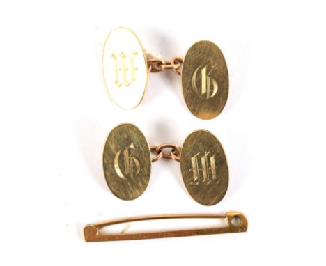 A pair of yellow metal cufflinks and a yellow metal bar brooch. The cufflinks marked '9ct' and of oval form, 8.6g, the bar br