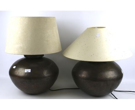 Two contemporary hammered metal table lamps. Labels to underside 'made in India' with lamp shades, approximately 35cm high ex