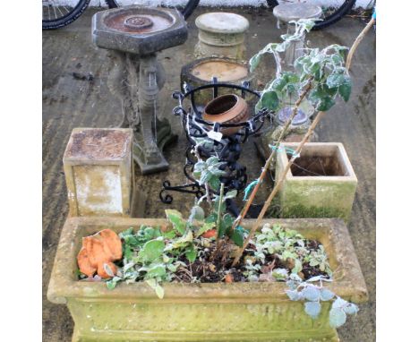 An assortment of garden ornaments and stands. Including composite stone bird baths and pedestals, a cast metal plant stand, a