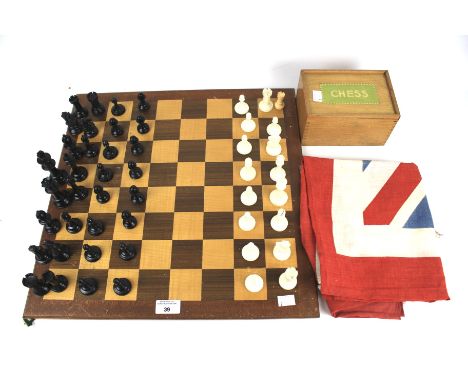 A Chad Valley chess set and two Union Jack flags. The plastic chess pieces within a wooden box with sliding lid, board measur