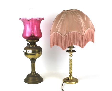 Two brass lamps. Comprising a table lamp with twist stand, H39cm (excluding shade) and a gas lamp with pink glass shade, H51c