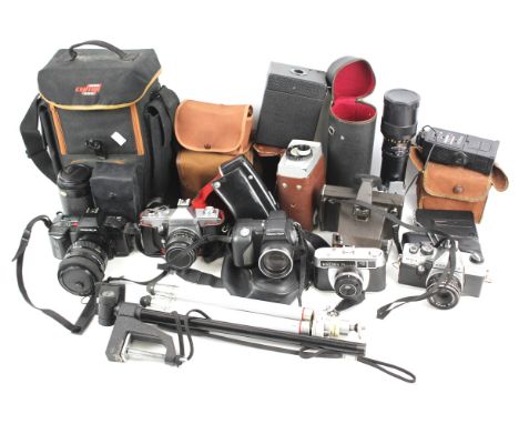 An assortment of cameras. Of various styles including a Yashica tripod lenses, etc