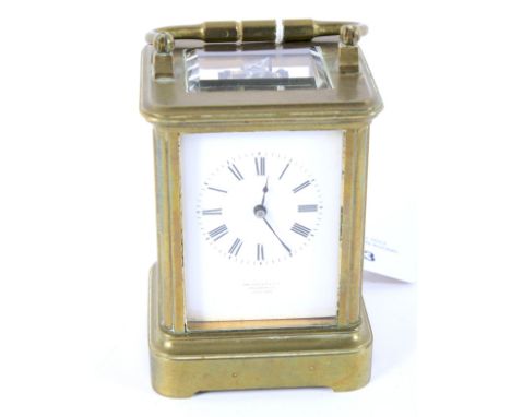 An early 20th century small brass cased carriage clock retailed by Ortner &amp; Houle. The enamel dial with Roman numerals de