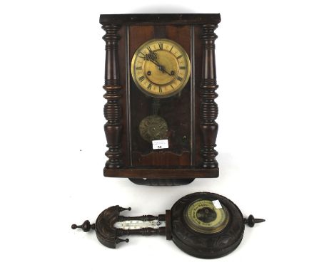A Victorian barometer and wall clock. The barometer with a thermometer positioned above the dial, within a carved wooden case