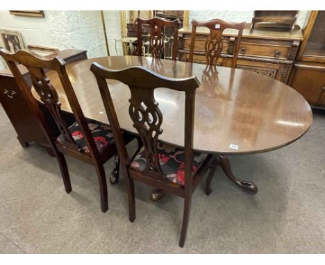 Mahogany twin pedestal extending dining table and leaf together with a set of four Chippendale style dining chairs.