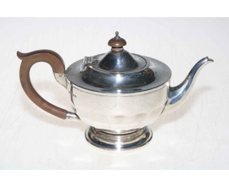 Silver teapot with panelled circular body, 14cm high, Birmingham 1931.