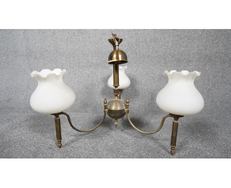A three branch brass hanging ceiling light with three blown milk glass shades with fluted edge. H.50 W.58 