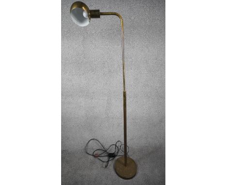 A Mid Century apothecary style solid brass height adjustable floor lamp. Domed shade has painted white interior and sits on a