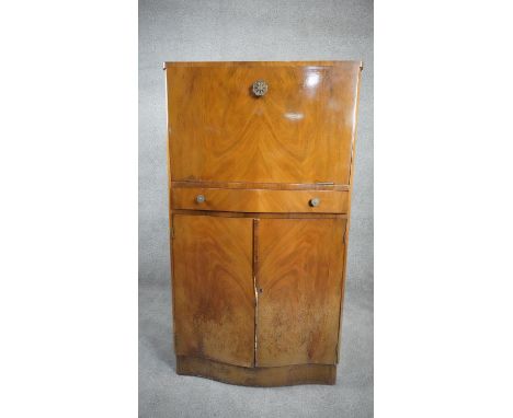 A 1950's burr walnut Art Deco style drinks cabinet with fitted interior to the top and base sections with original cocktail s