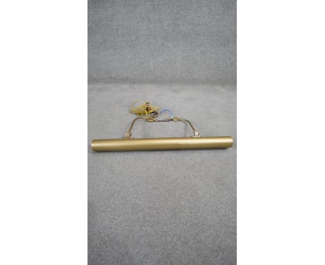 A wall mounted gilt metal picture light with four spotlight bulbs and silk wrapped cord. H.30 W.62 