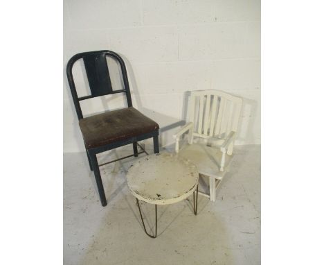 A vintage metal framed chair, along with a small circular metal table and painted child's chair.